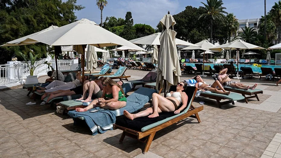 Vacationers Sprint for Poolside Lounge Chairs at Spanish Resort After Hour-Long Wait